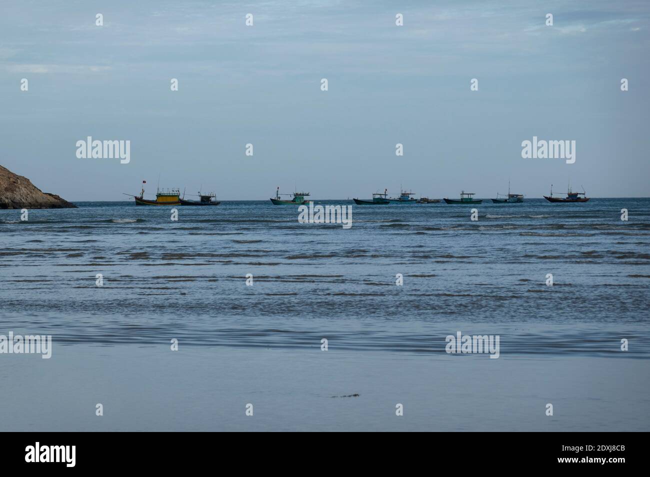 Small fishing boats out at sea in Vietnam Stock Photo