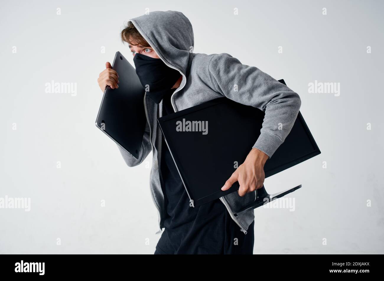 hooded man mask technology theft illegal penetration bully Stock Photo -  Alamy