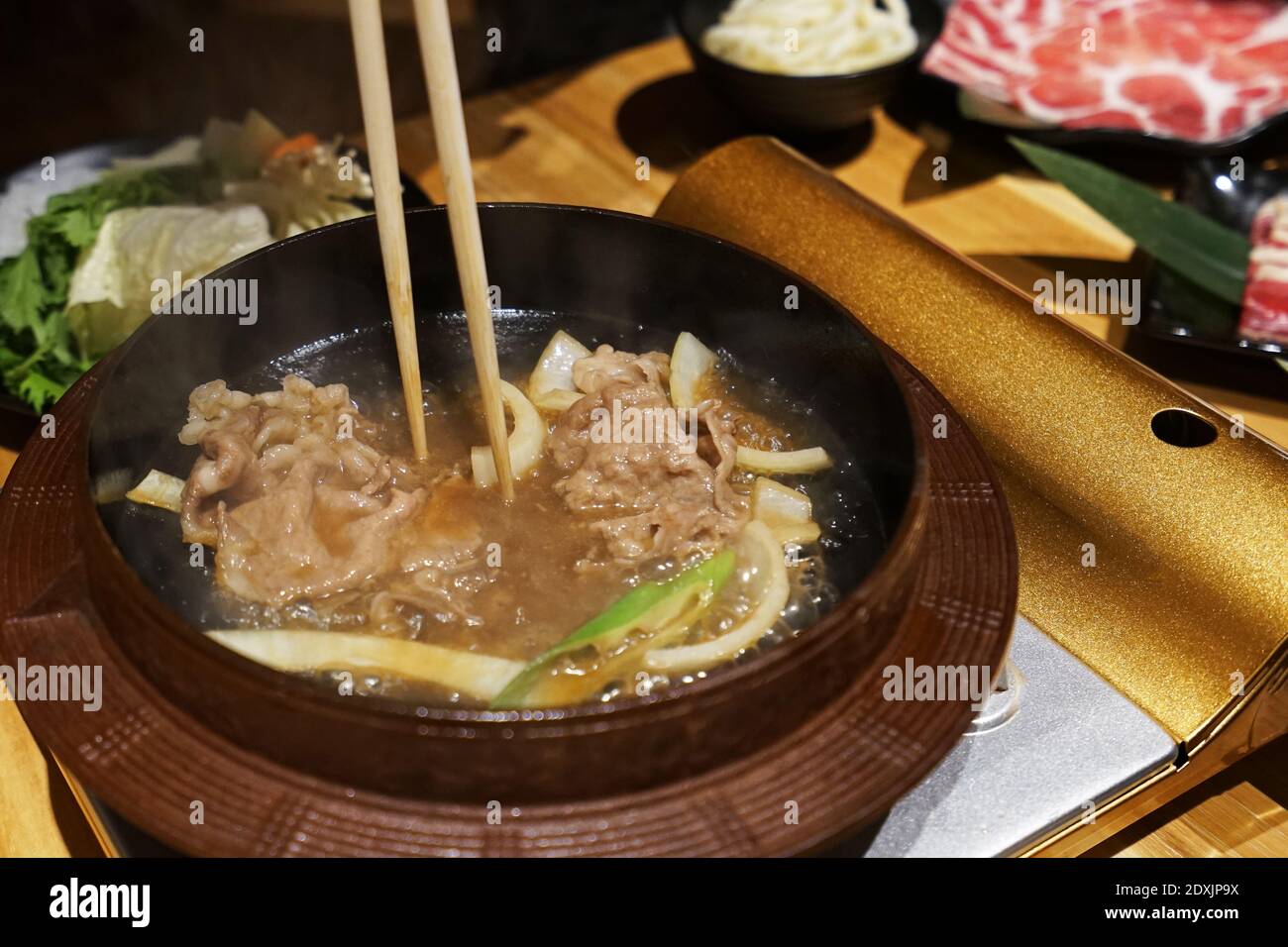 Wooden table fulled of vegetables, Sliced Wagyu beef and pork, raw egg