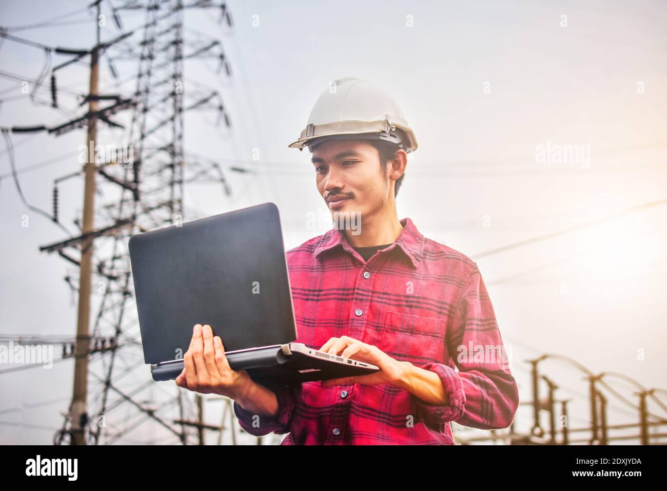 Engineer technician foreman Supervisor holding computer notebook at work place Power plant electric system background technology inspection Checking s Stock Photo