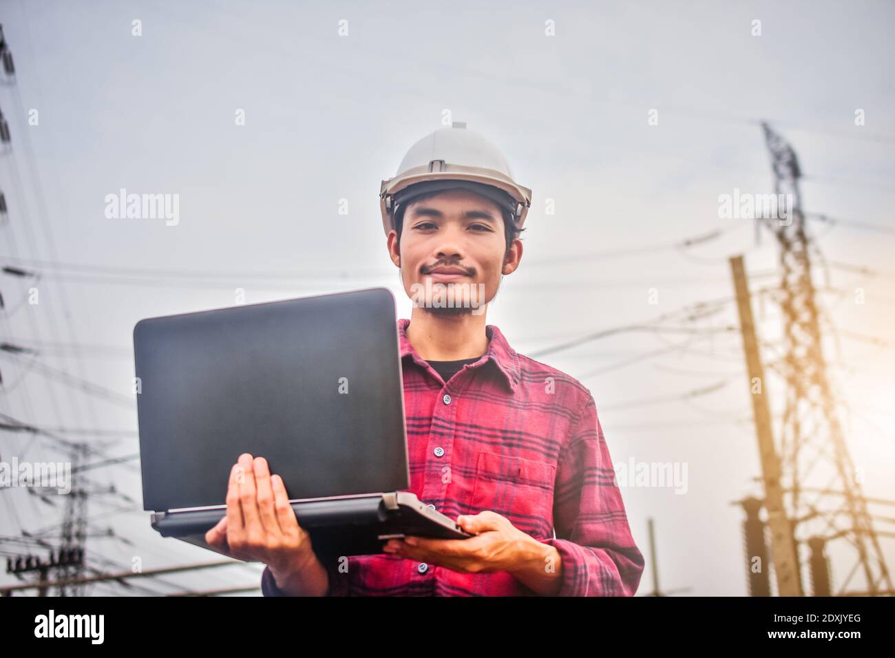 Engineer technician foreman Supervisor holding computer notebook at work place Power plant electric system background technology inspection Checking s Stock Photo
