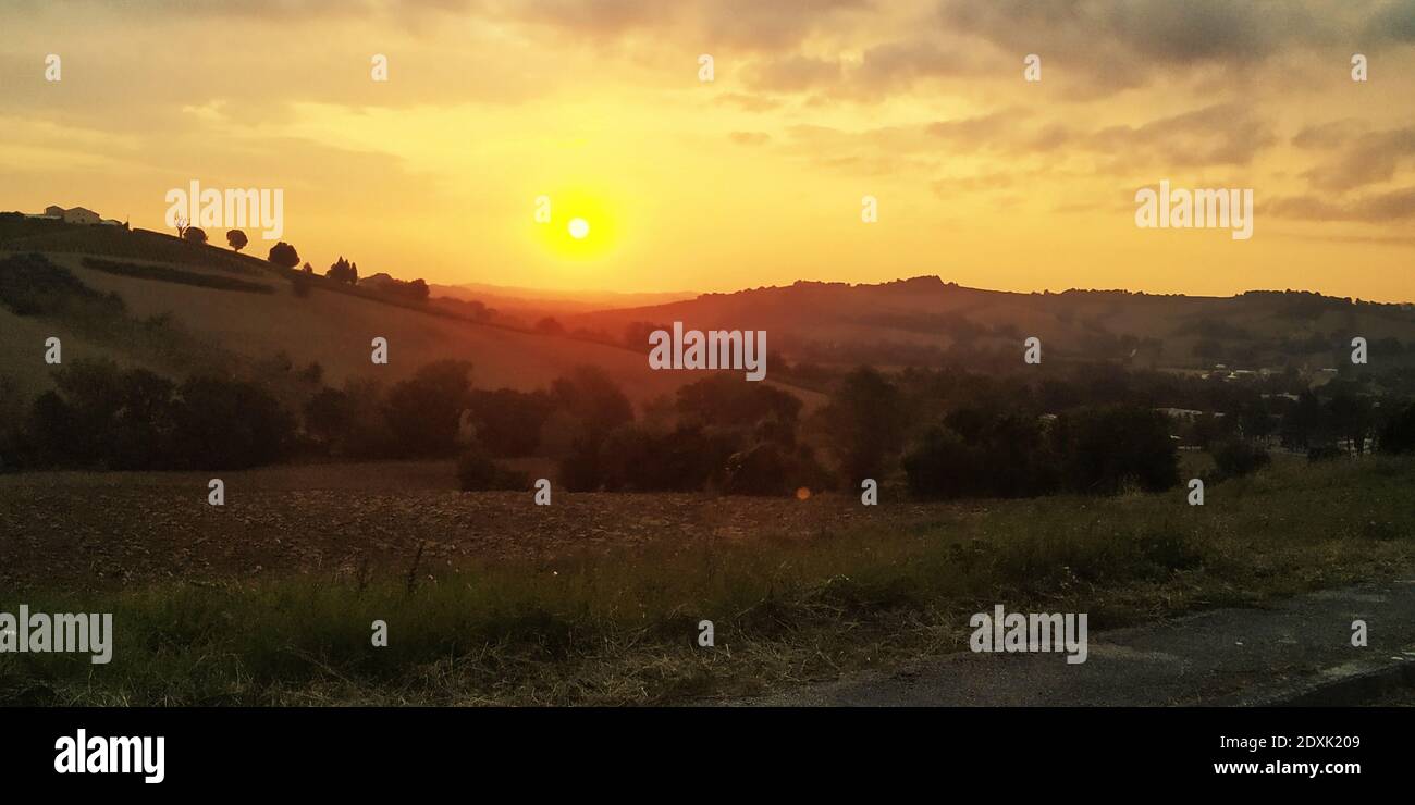 Scenic View Of Landscape Against Sky During Sunset Stock Photo