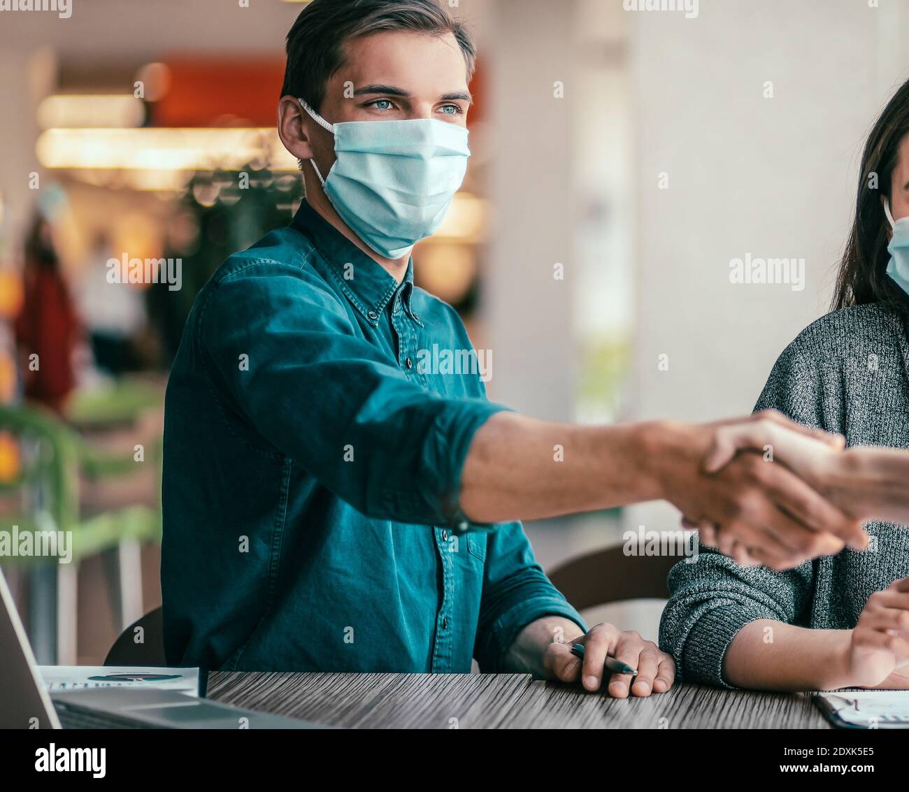 business people shaking hands over an office Desk Stock Photo Alamy