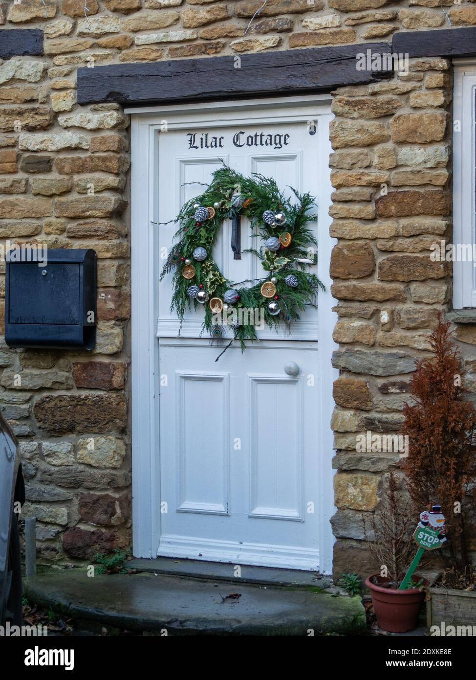 Christmas wreath on the front door of a cottage in the village of Milton Malsor, Northamptonshire, UK Stock Photo