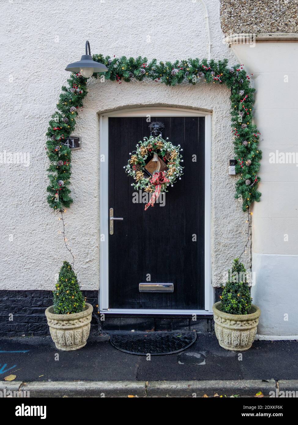 Christmas wreath on the front door of a cottage in the village of Milton Malsor, Northamptonshire, UK Stock Photo