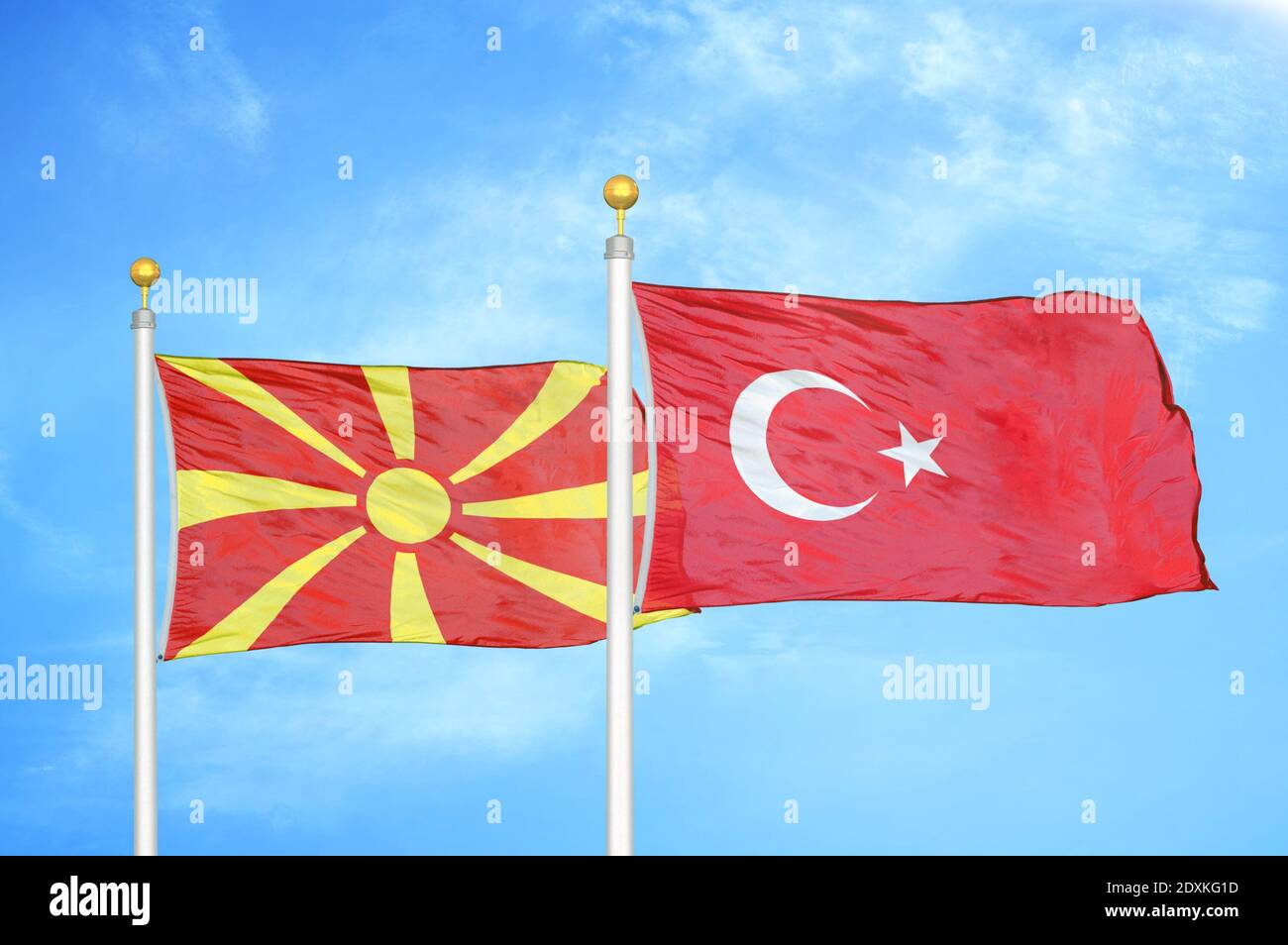 North Macedonia and Turkey two flags on flagpoles and blue sky Stock Photo