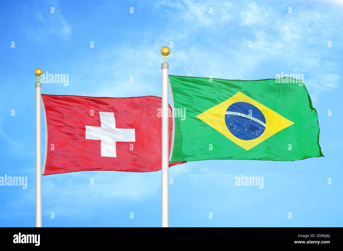 Switzerland and Brazil two flags on flagpoles and blue sky Stock Photo