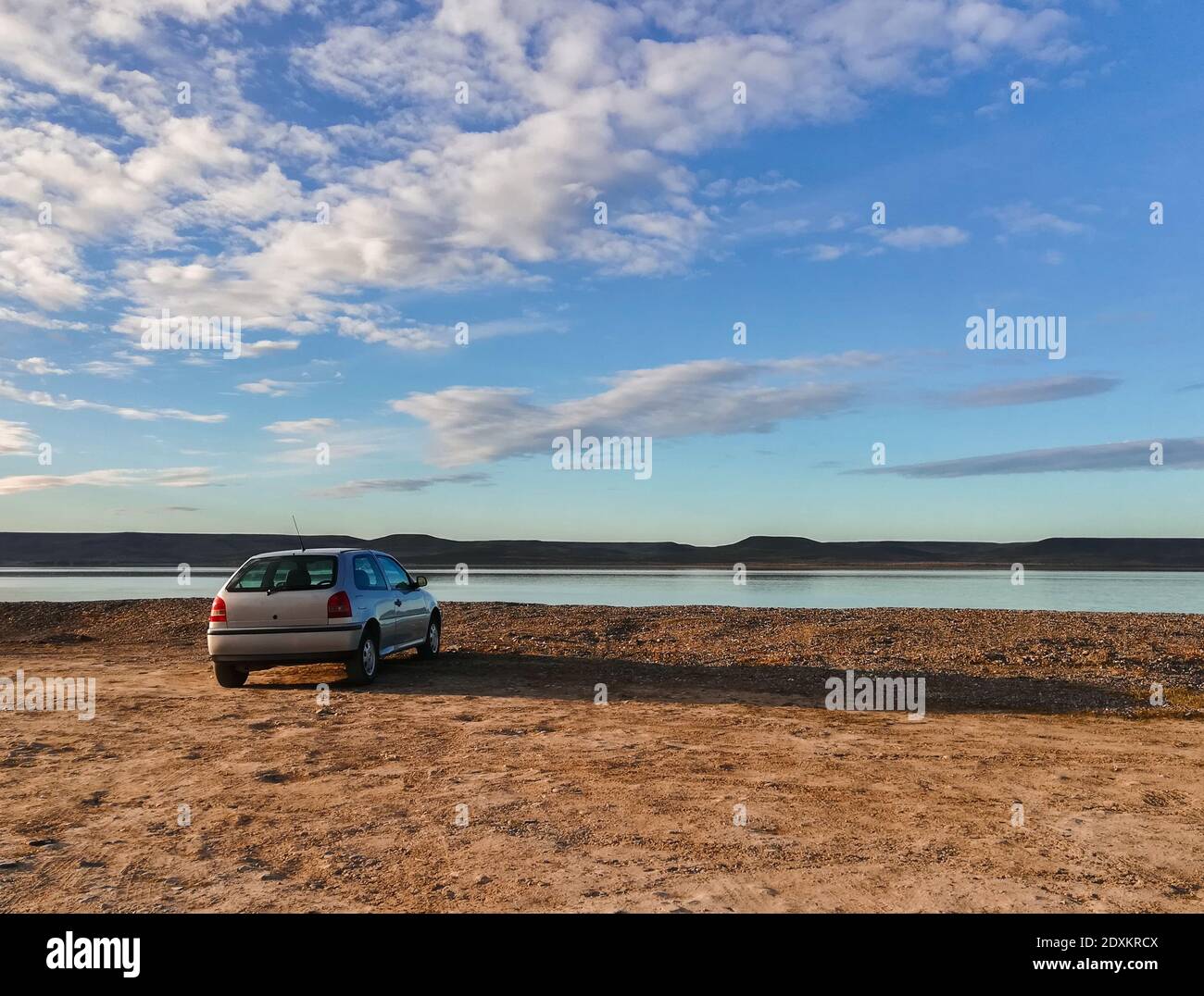 RIO GA, ARGENTINA - Sep 08, 2019: beautiful landscape and car without recognizable marks or information, coastline with water view, mountains, brown l Stock Photo