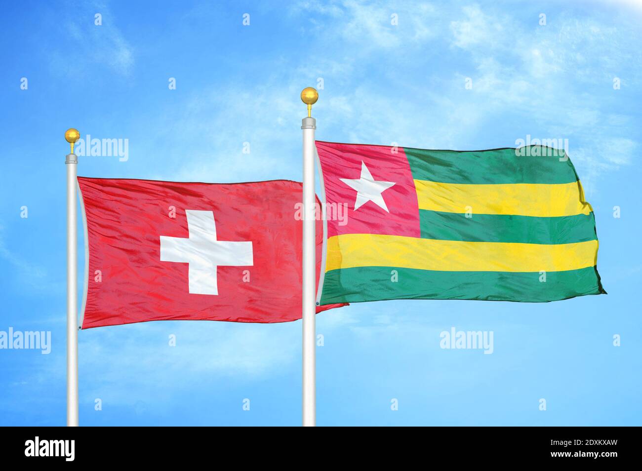 Switzerland and Togo two flags on flagpoles and blue sky Stock Photo