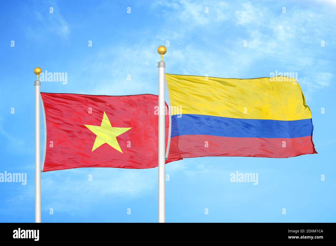 Vietnam and Colombia two flags on flagpoles and blue sky Stock Photo