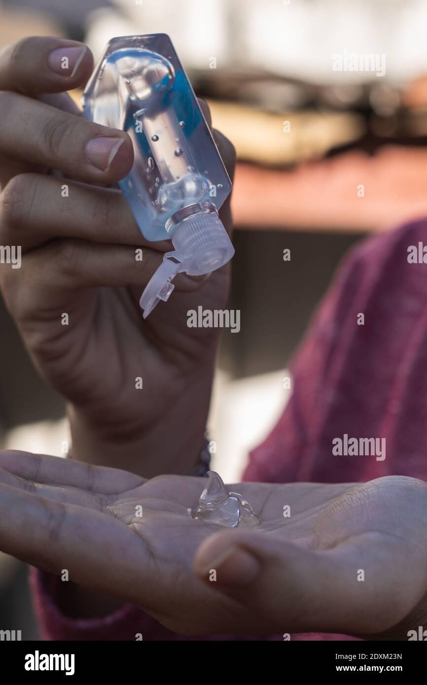 A female disinfecting her hands with gel alcohol or hand sanitizer gel ...