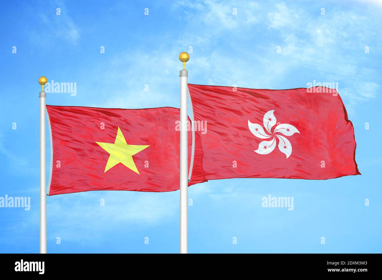 Vietnam and Hong Kong two flags on flagpoles and blue sky Stock Photo