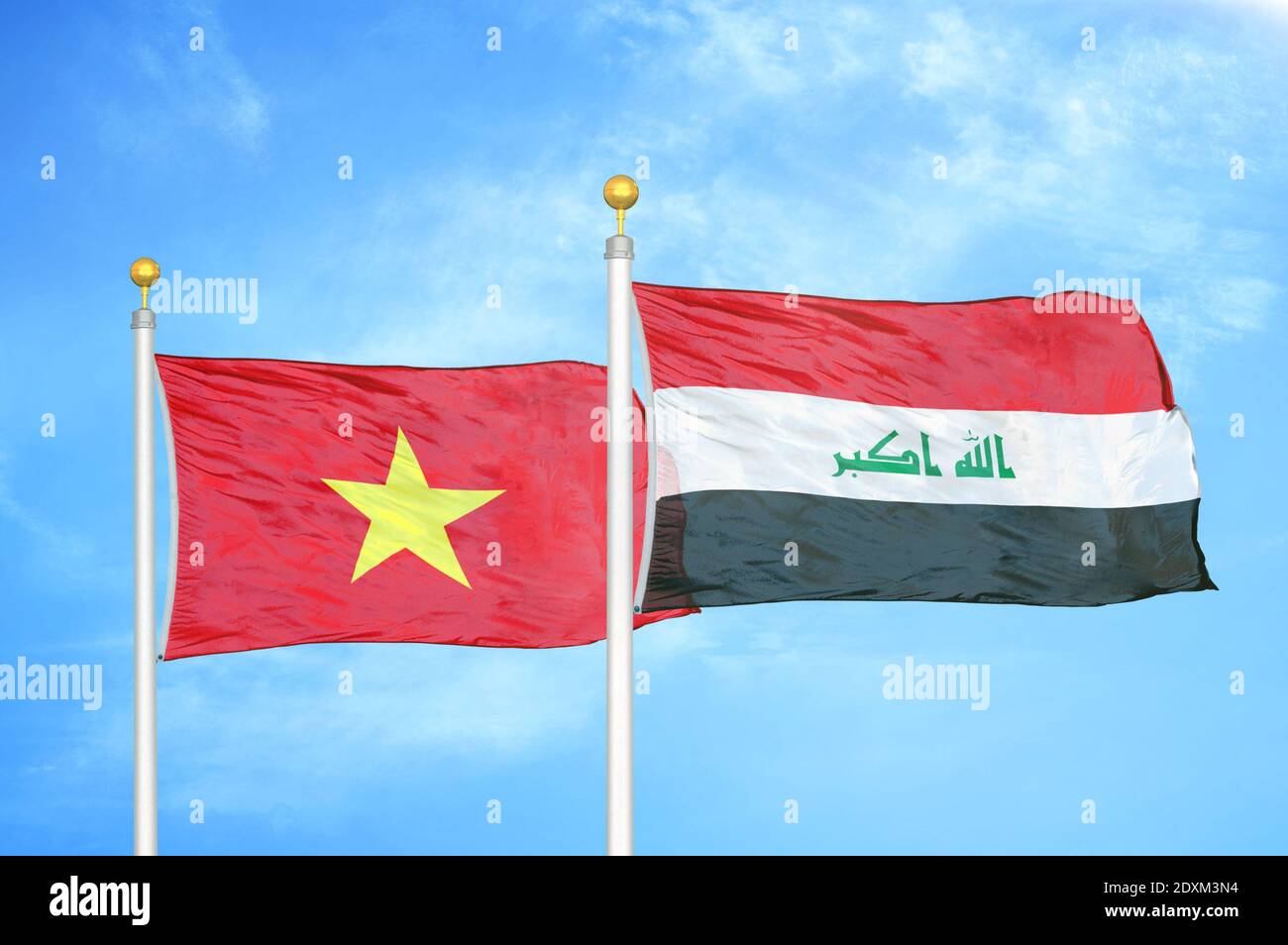 Vietnam and Iraq two flags on flagpoles and blue sky Stock Photo