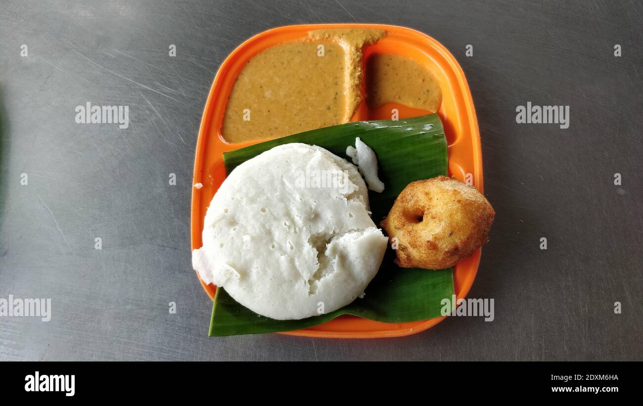 A top view of a lunchbox with South Indian Idly and Voda Stock Photo