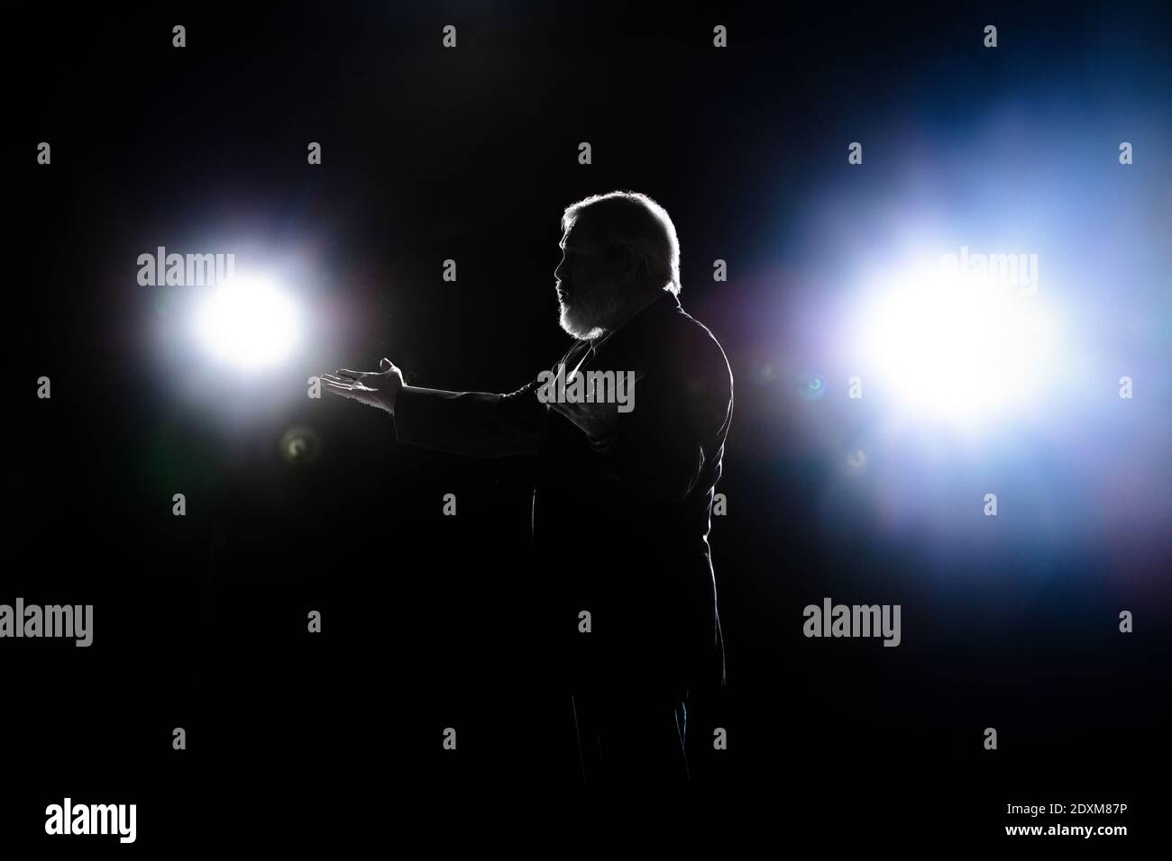 Elderly man silhouette gesturing isolated on dark background Stock ...