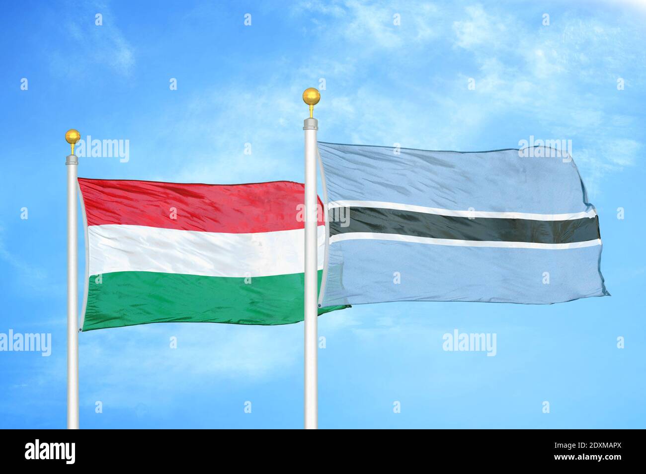 Hungary and Botswana two flags on flagpoles and blue cloudy sky Stock ...