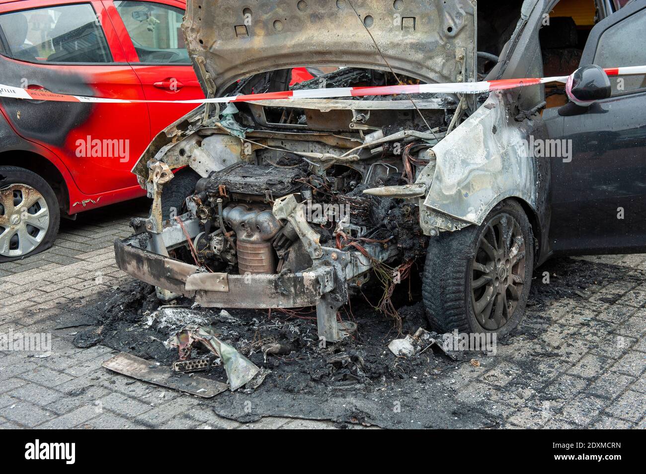 Wreck of a car after it got on fire during the night Stock Photo