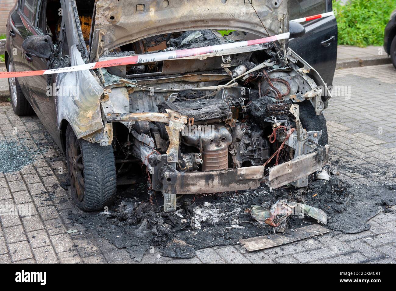 Wreck of a car after it got on fire during the night Stock Photo