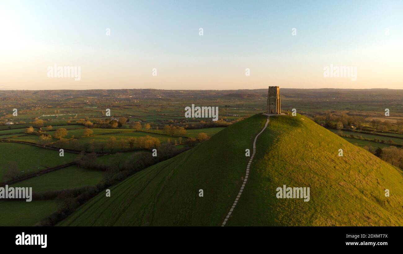 Aerial view of of the early morning sunrise over Glastonbury Tor with Somerset fields below. Stock Photo