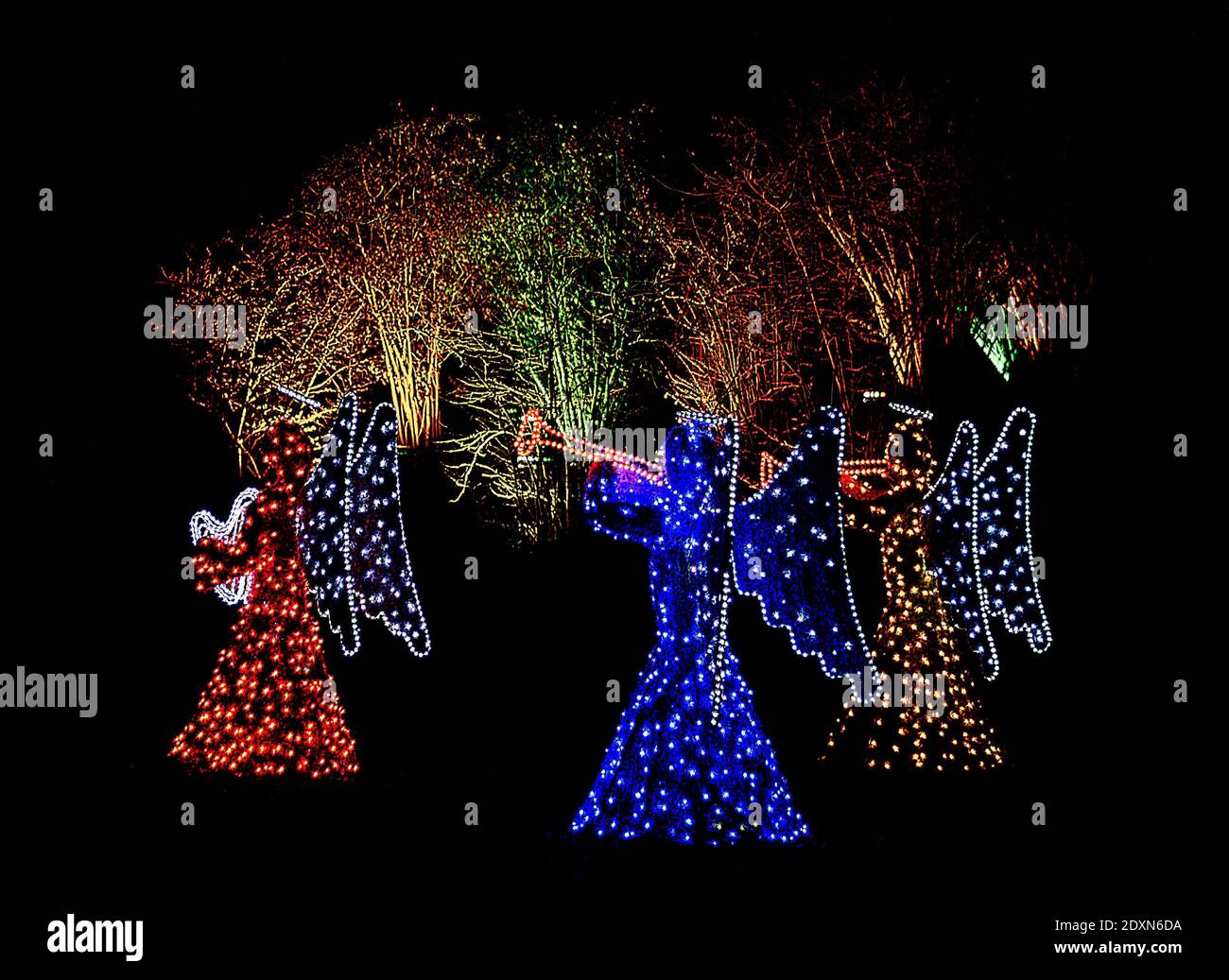 Outdoor christmas illumination of three angels playing music instruments Stock Photo