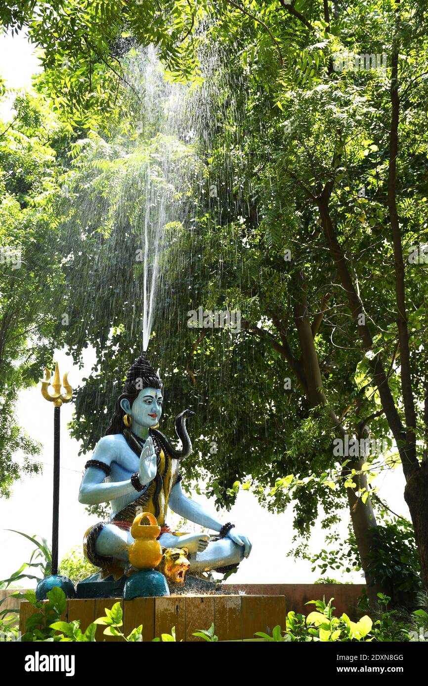 Statue of lord Shiva and Background raining Stock Photo - Alamy
