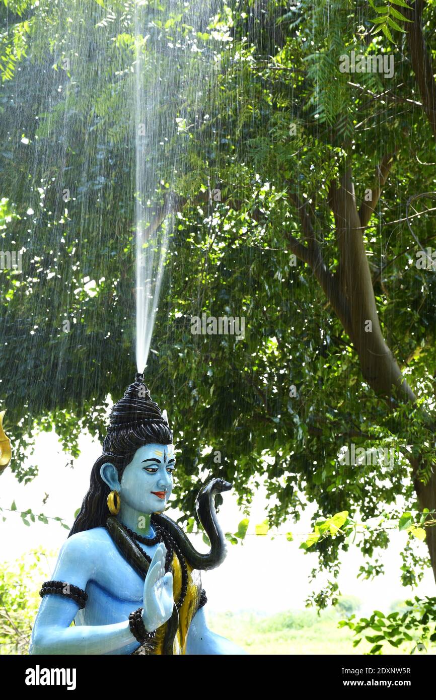 Statue of lord Shiva and Background raining Stock Photo - Alamy