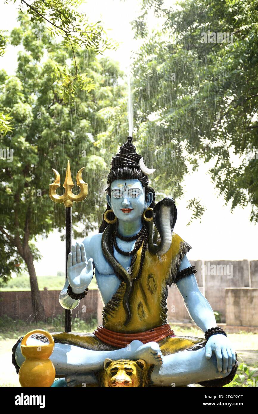 Statue of lord Shiva and Background raining Stock Photo - Alamy