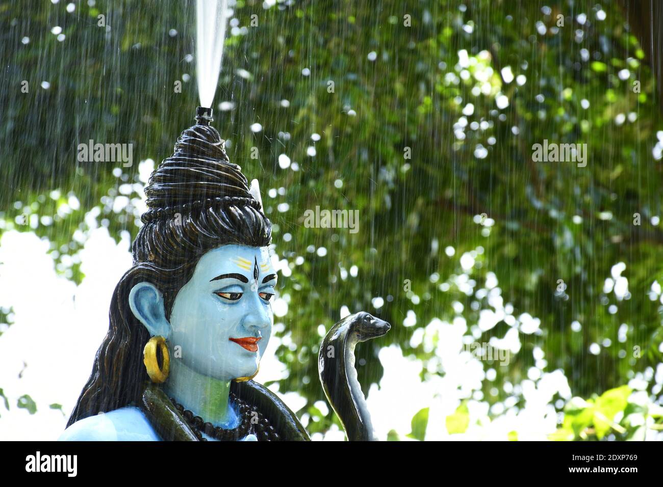 Statue of lord Shiva and Background raining Stock Photo - Alamy