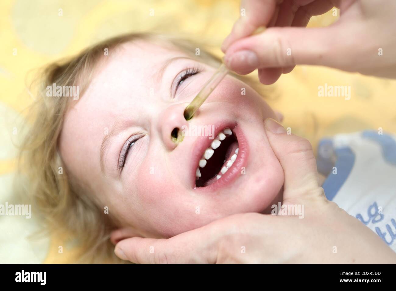 Treatment of the common cold of child at home Stock Photo
