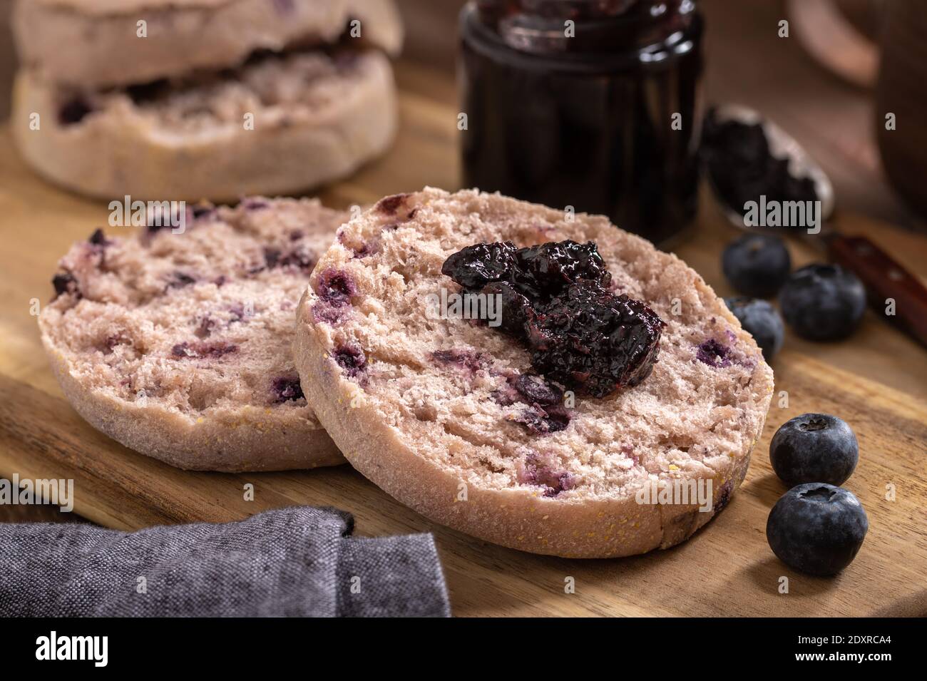 Blueberry English Muffin Split In Half And Spread With Preserves And Fresh Blueberries On A Wooden Cutting Board Stock Photo Alamy