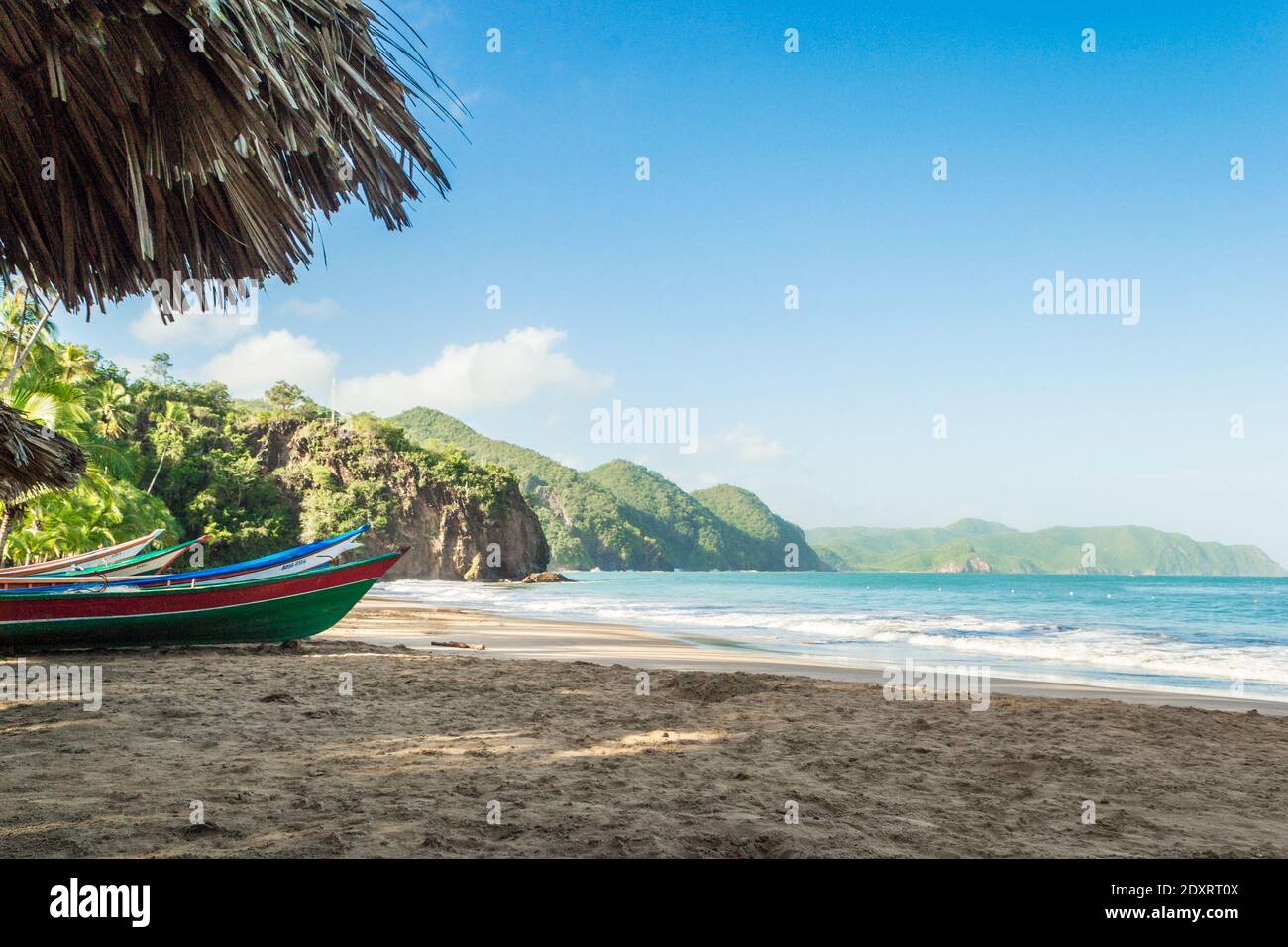 A beautiful shot of colorful boats standing at the seaside in the shadow. A relaxing seascape Stock Photo