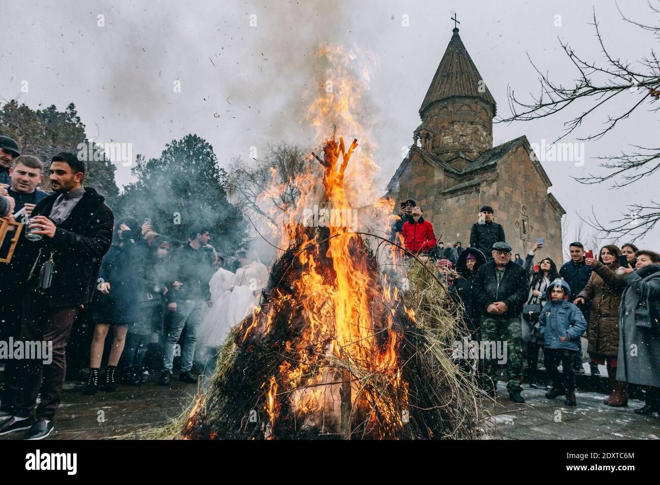 Ashtarak, Armenia, Saint Marianeh church, January 14, 2020 - Armenians celebrating Trndez, holding their hands and walking around the fire Stock Photo