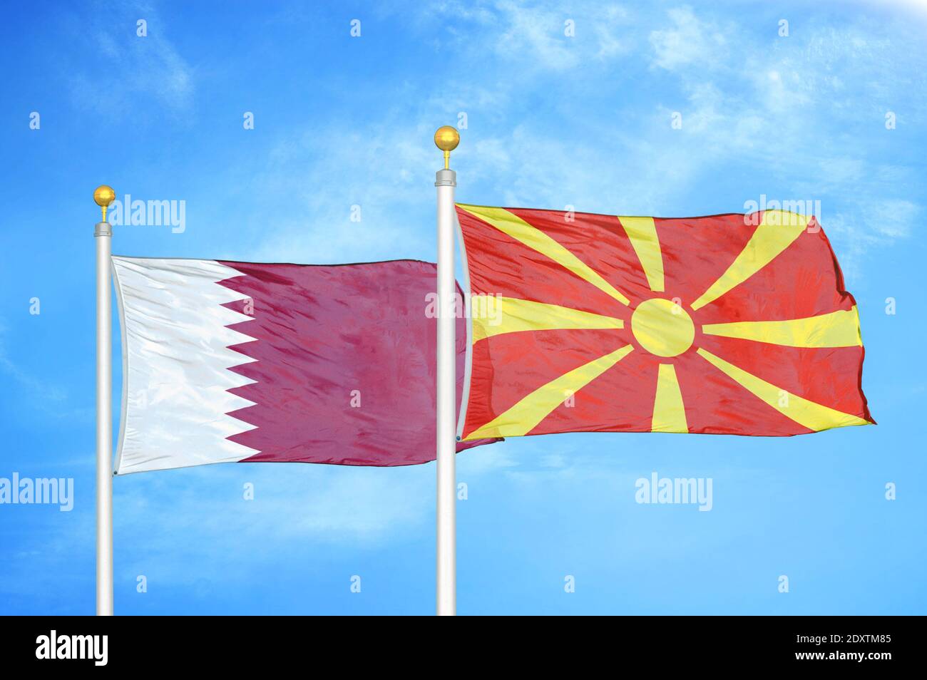 Qatar and North Macedonia two flags on flagpoles and blue cloudy sky Stock Photo Alamy