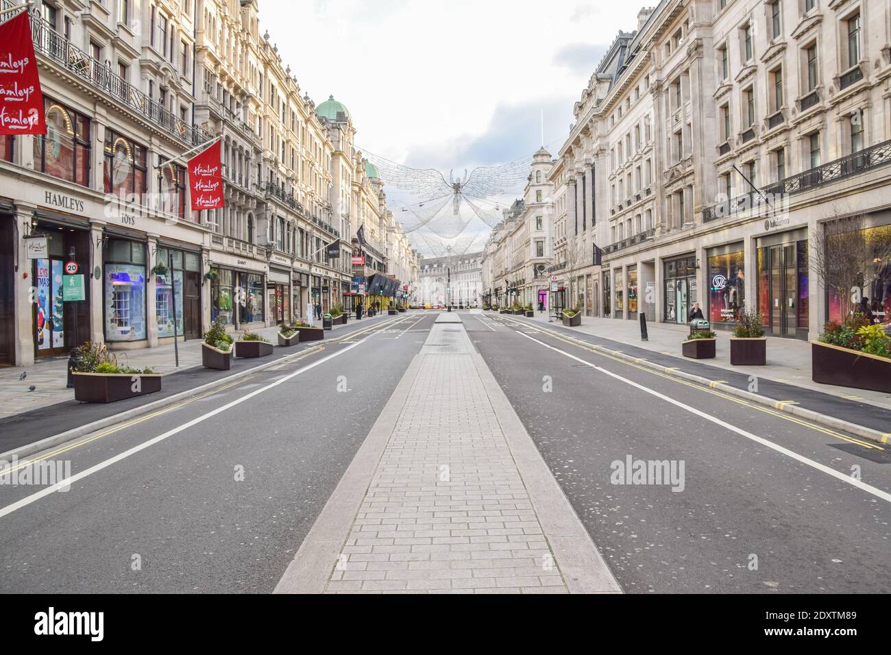 A view of a deserted Regent Street, as shops and businesses close once again. London has been placed under Tier 4 restrictions as cases surge and new strains of COVID-19 emerge in England. Stock Photo