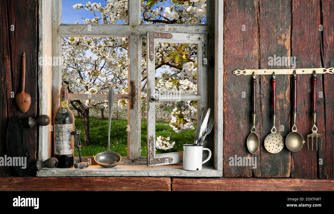 rustic farmer's kitchen with a view of the landscape through a wooden window Stock Photo