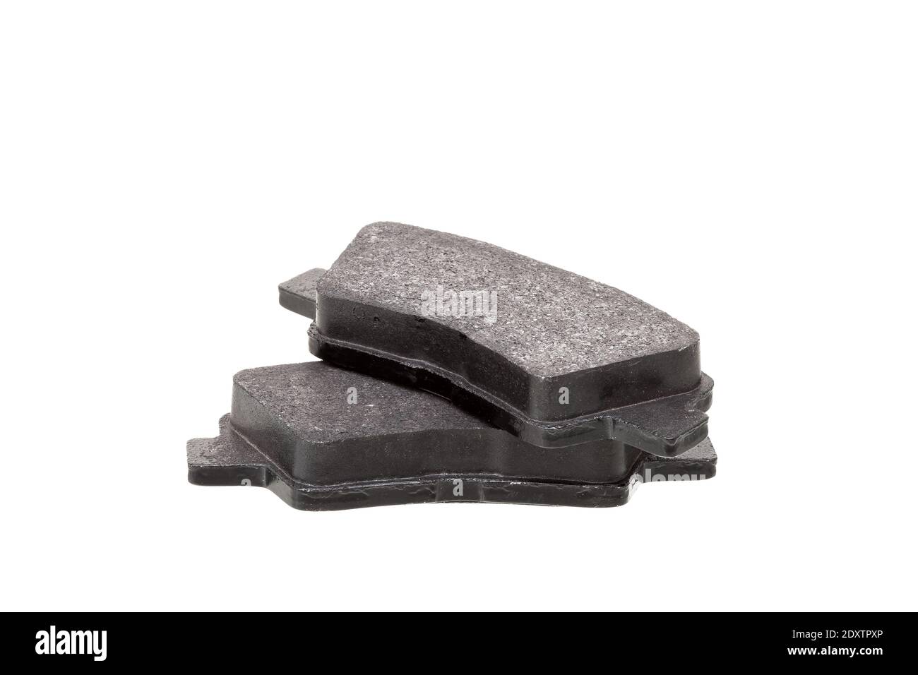 brake pads one on top of the other demonstrate the thickness of asbestos abrasive coating, new car spare parts isolated on white background side view. Stock Photo