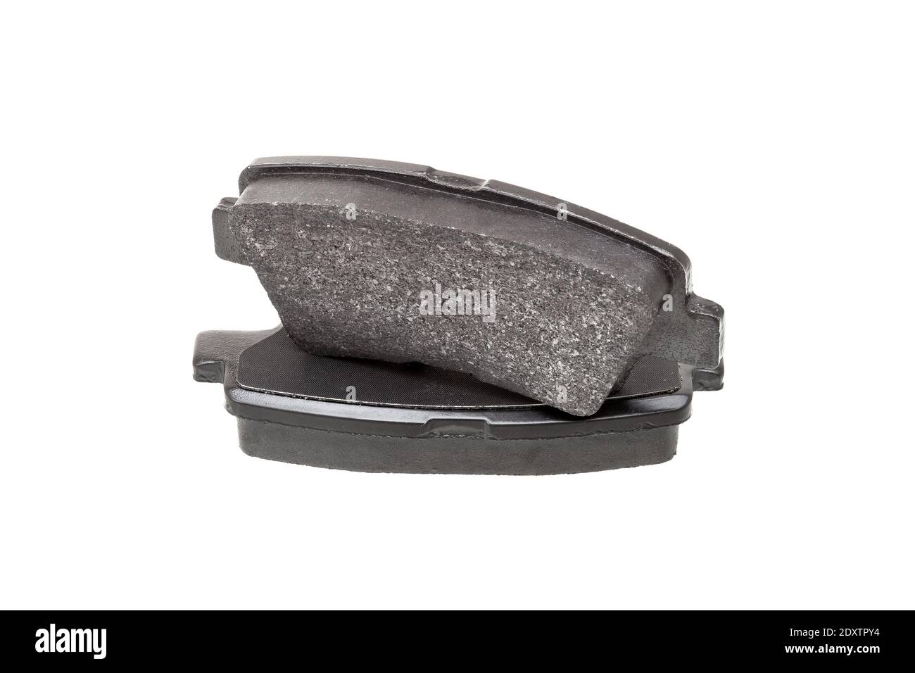brake pads one on top of the other demonstrate the thickness of asbestos abrasive coating, new car spare parts isolated on white background. Stock Photo