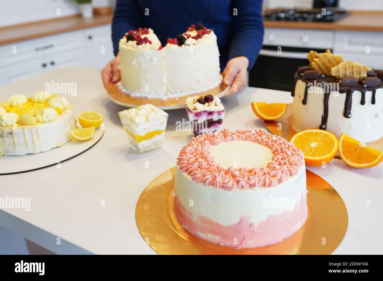 Table with various cakes, tarts, cupcakes and sweet desserts Stock