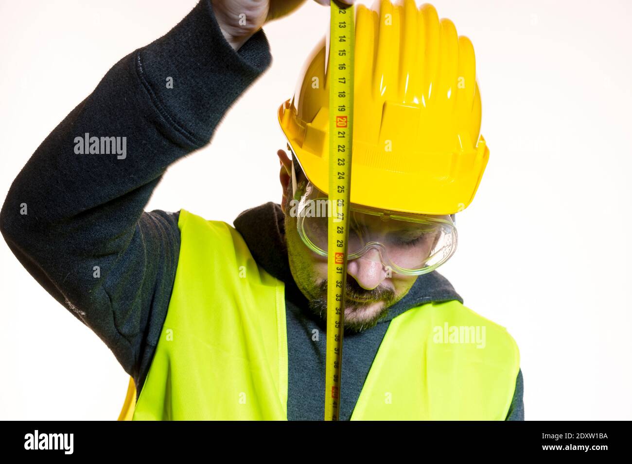 Architect Measuring With Tape Measure Against White Background Stock