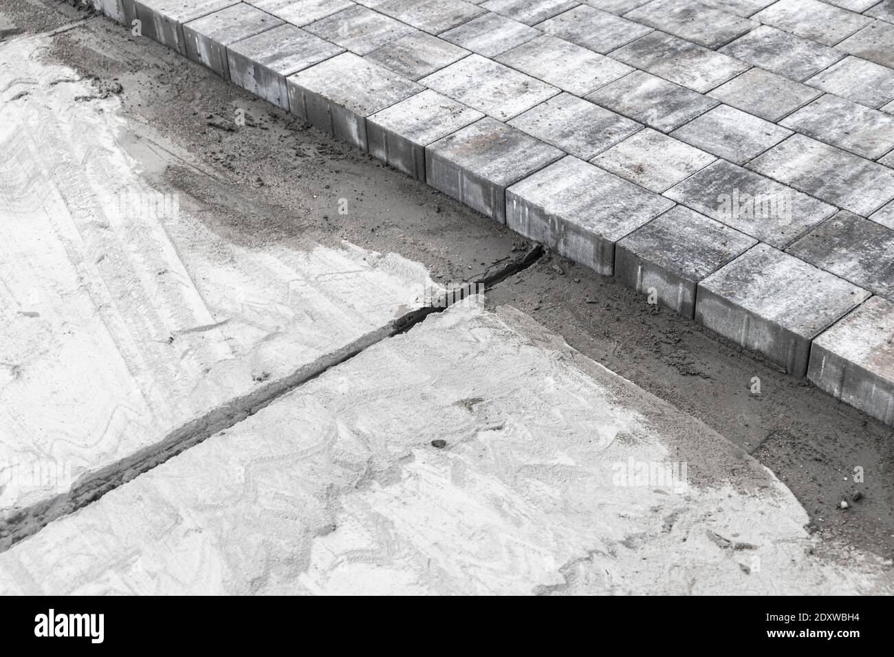 Laying of paving slabs, ground preparation with dry cement sand mixture