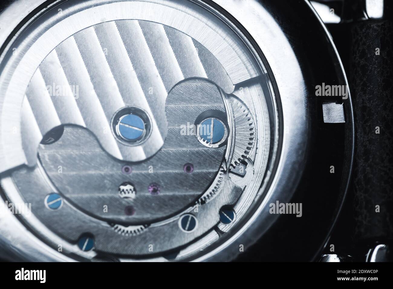 Back side of a mechanical luxury men wrist watch with automatic winding, close-up photo of self-winding mechanism details Stock Photo