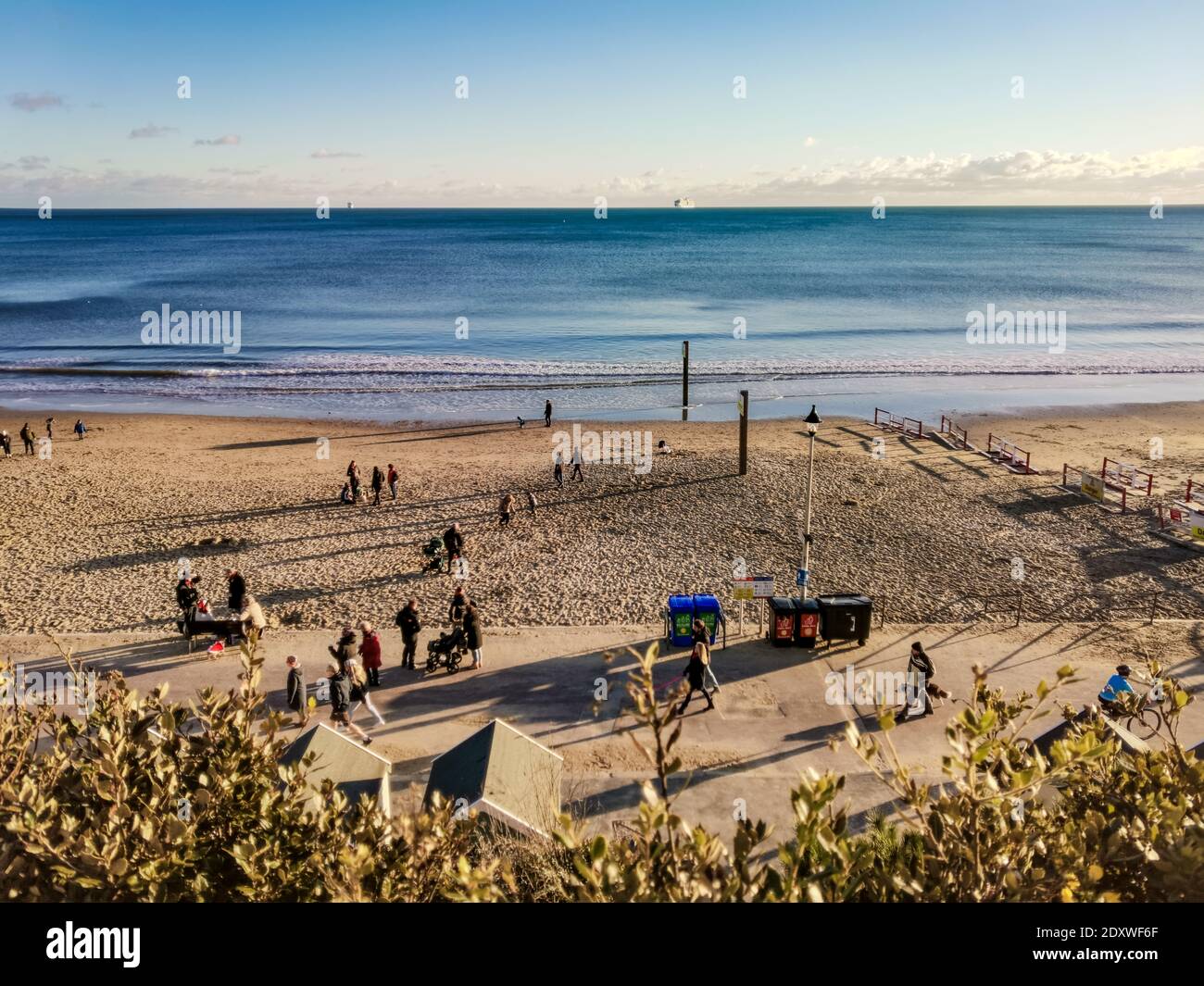 Bournemouth, UK. 24th Dec, 2020. People on the beach enjoy some winter sun in Bournemouth. Credit: Thomas Faull/Alamy Live News Stock Photo