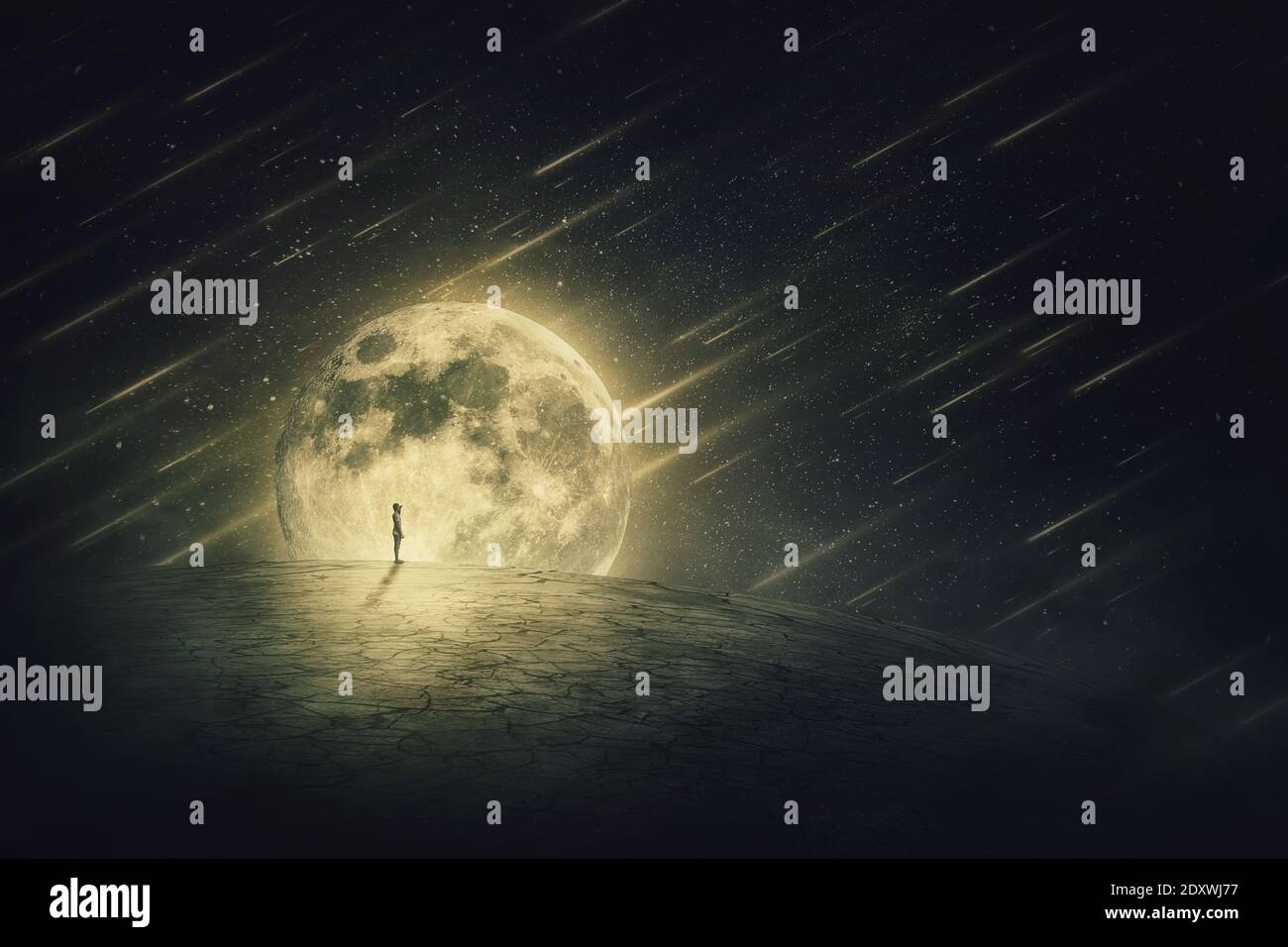Surreal world scene with a person silhouette, alone on a dry empty land, looking at the starry night sky with comets falling, over a full moon backgro Stock Photo