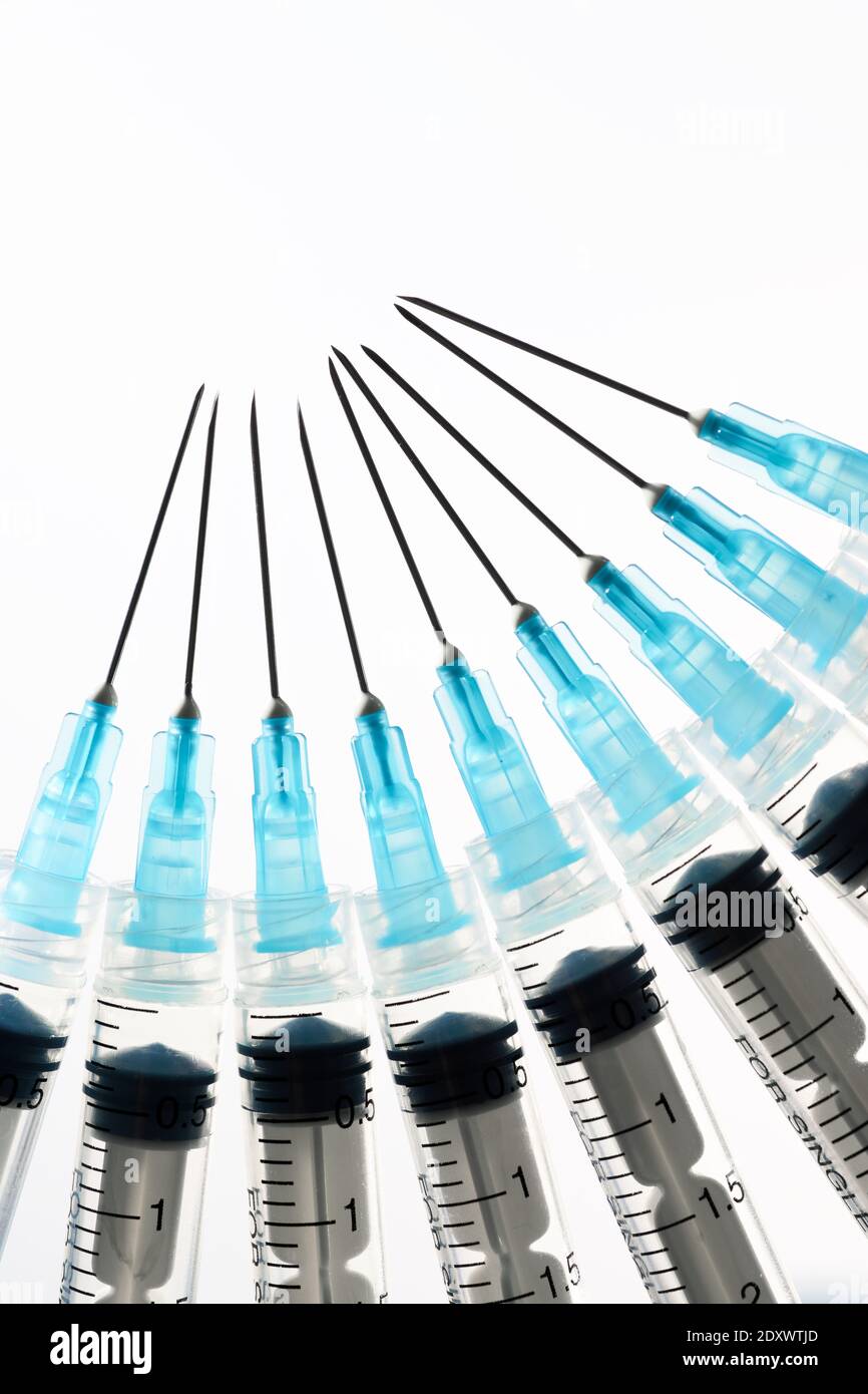 Close up of a group of syringes on a white backlit table Stock Photo ...