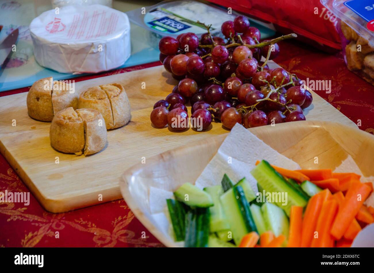 A selection of snacks laid out on a a table including crudites, red