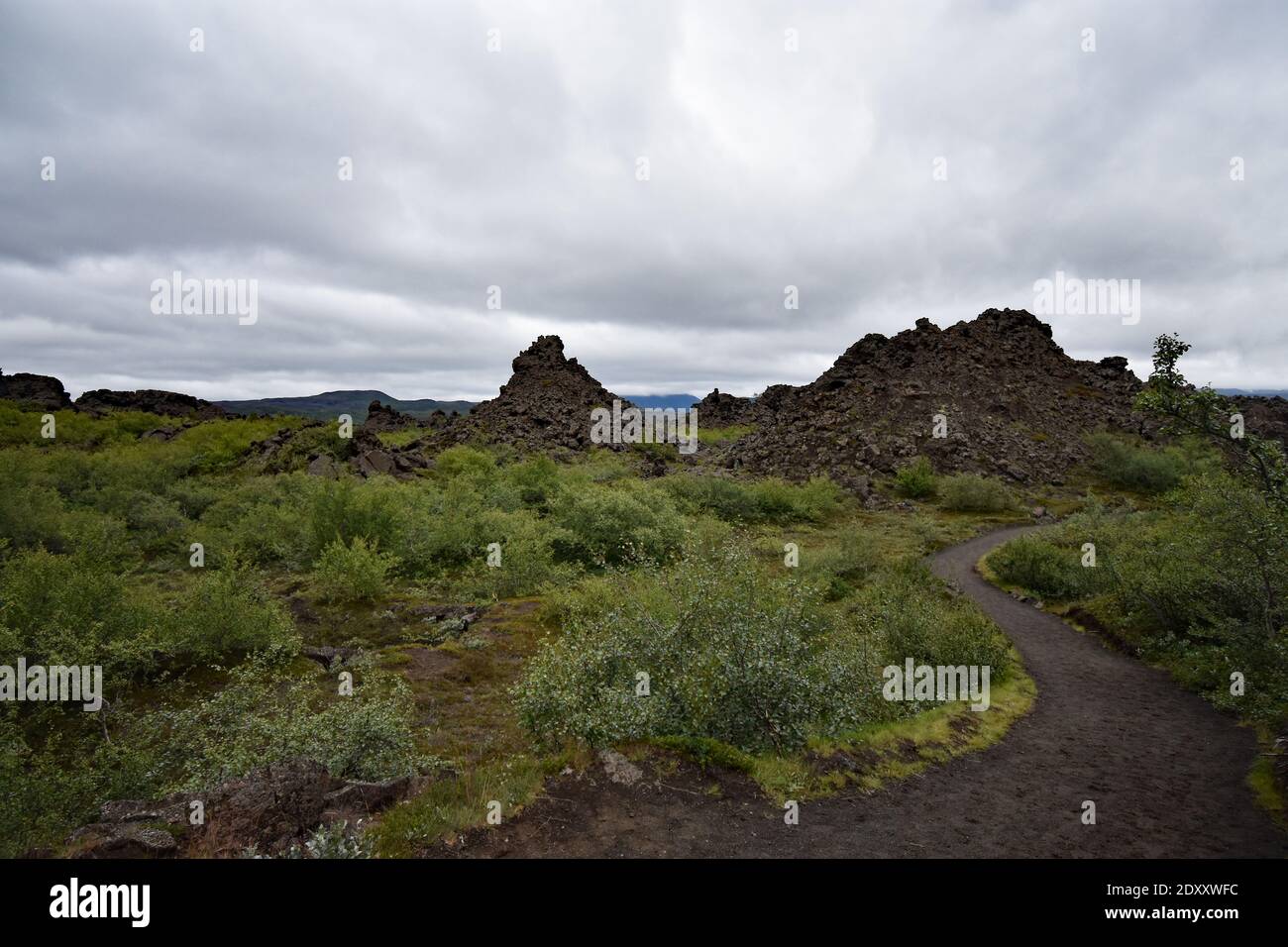 A path winds through Dimmuborgir (Dark Castles), a large area of unusually shaped lava fields east of Lake Mývatn in Northern Iceland. Stock Photo