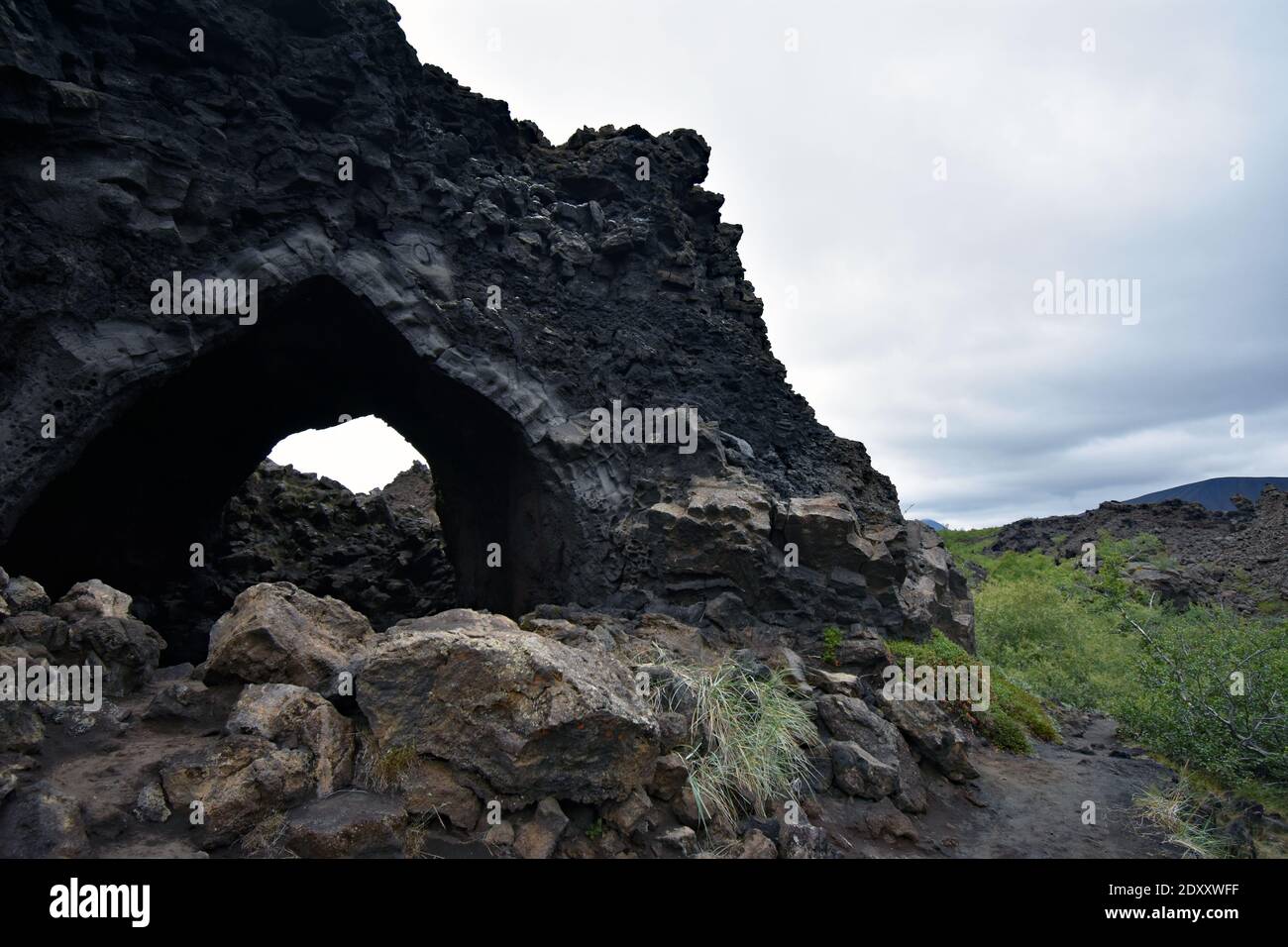 Kirkjan (the Church) a lava tube structure at Dimmuborgir in Lake Myvatn, Northern Iceland. Lava rock with a hole through the middle. Stock Photo