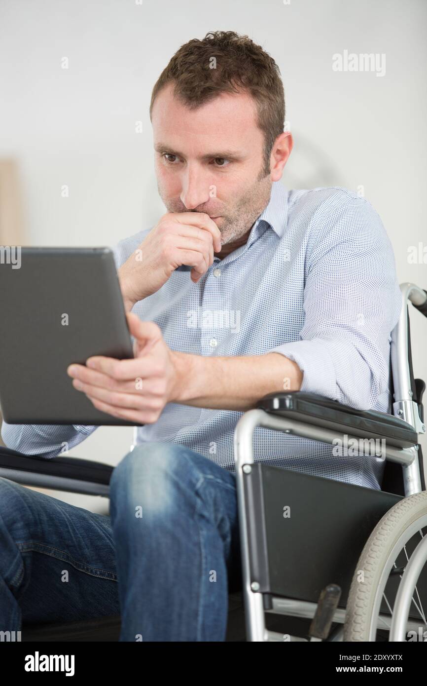 Wheelchair user using tablet hi-res stock photography and images - Alamy