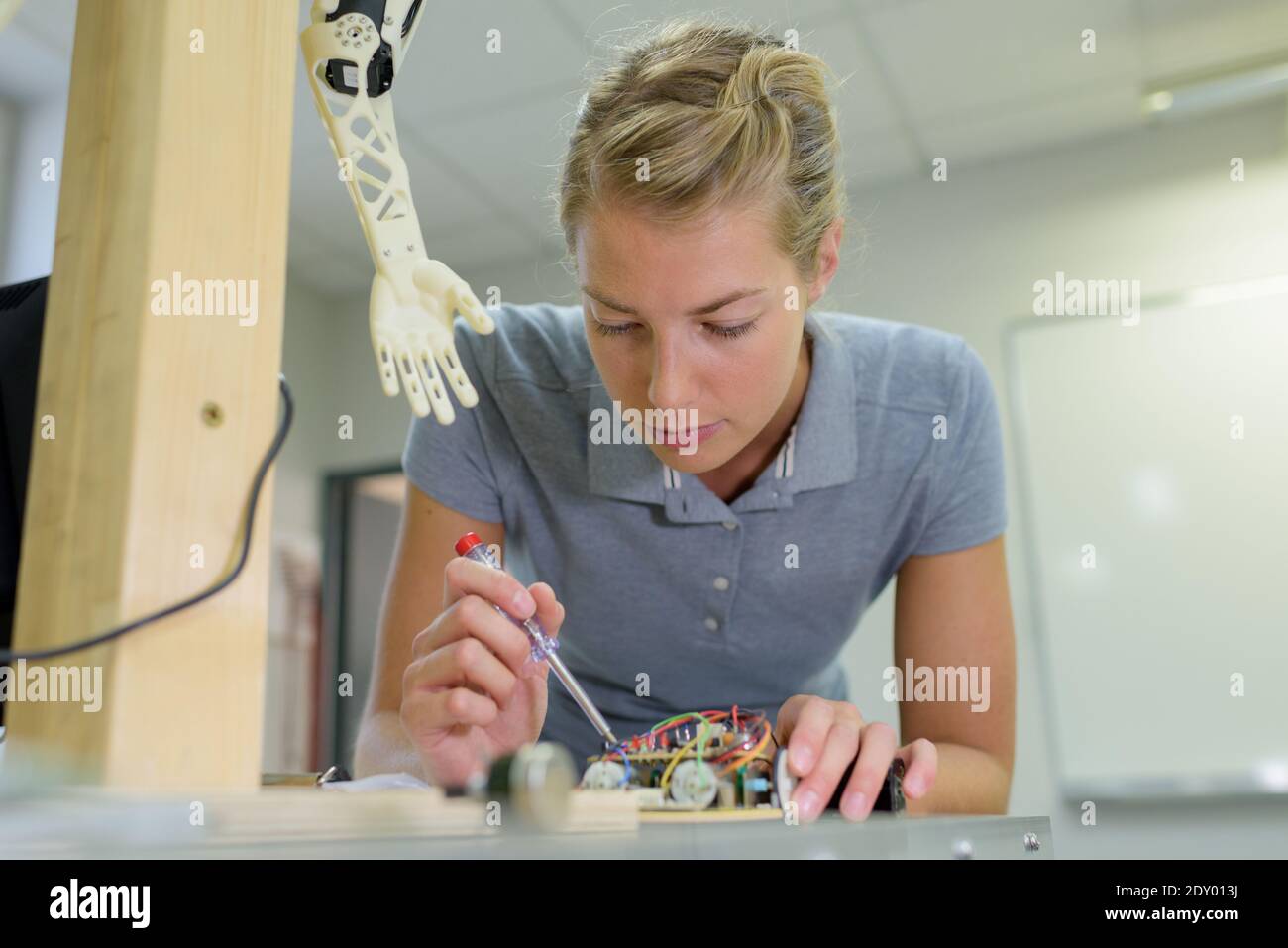 young female technician while machine constructing Stock Photo