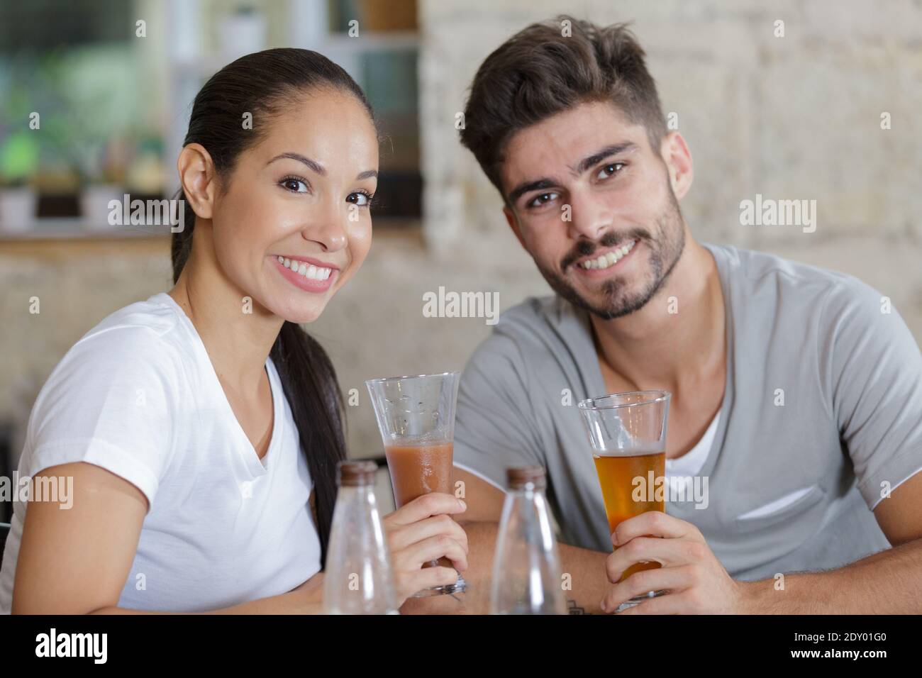 portrait of young couple having a drink in a bar Stock Photo Alamy
